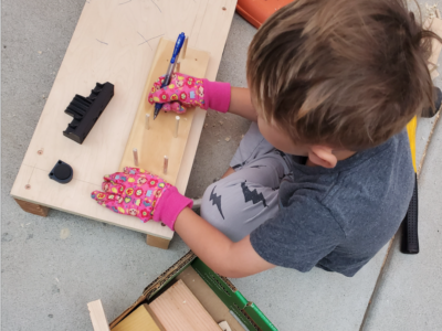 Little kid working with wood